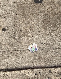 a piece of paper on the sidewalk